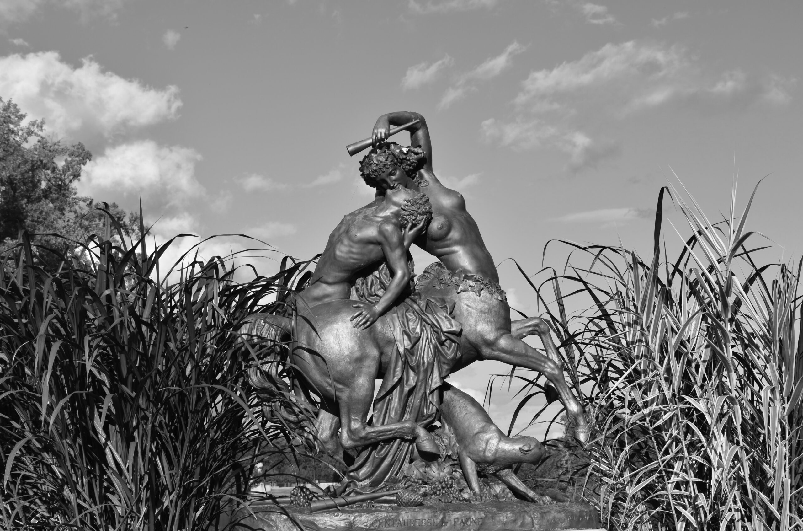A cropped, grayscale edit of a photo of the sculpture Centauress and Faun by Augustin Cortet.